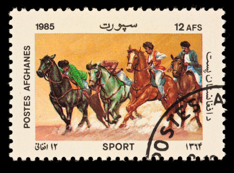 A postage stamp depicting the ancient Afghan team sport known as Buzkashi, played on horseback. It is popular in many south central Asian countries.